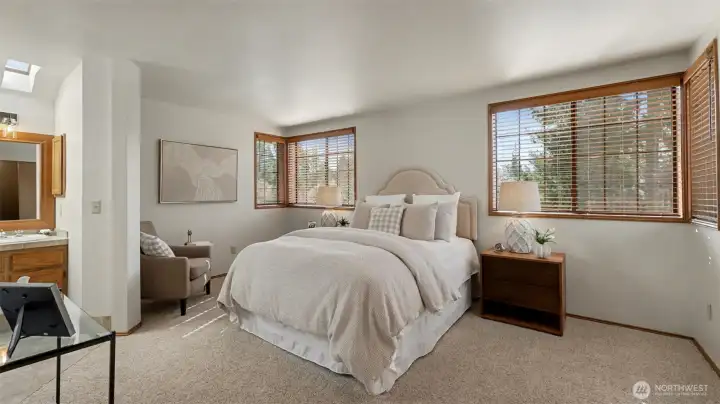 The primary bedroom is spacious with wonderful natural light.  All the window treatment have been replaced throughout the home.