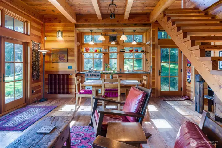 Custom interior made with reclaimed wood, heavy timber frame beams, and quality light fixtures make this space feel warm, and curated special for this unique location.