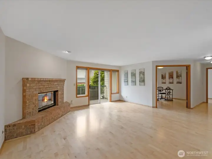 Alternate view of living room and fire place, plus balcony.