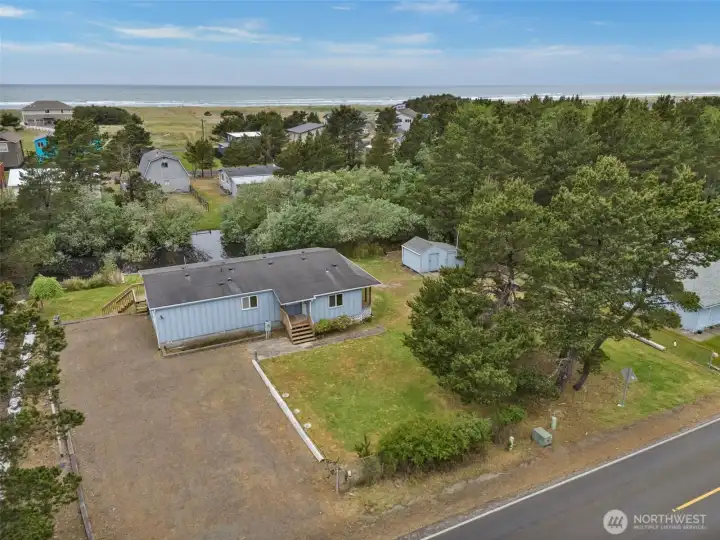 Alternate aerial angle highlighting the three-lot configuration, outbuildings, and nearby canal access.