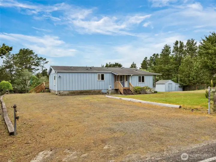 Front exterior of the home with expansive lot space and  driveway area.