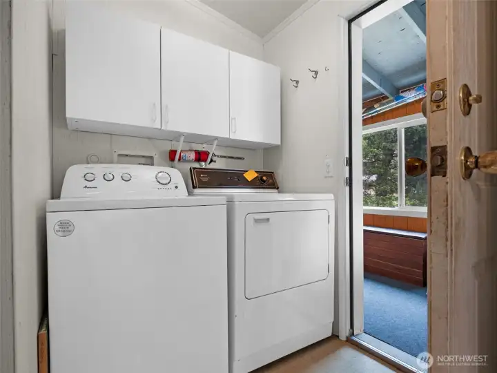 Laundry area with built-in cabinetry and additional storage space.