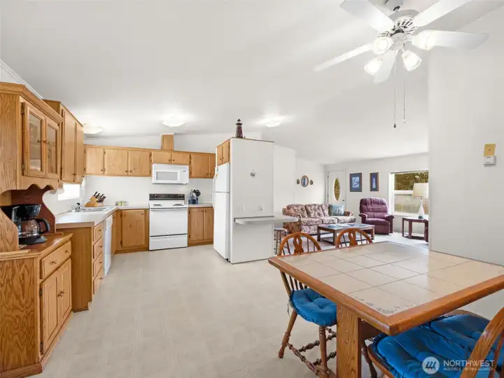 Open kitchen and dining area with breakfast bar and functional layout.