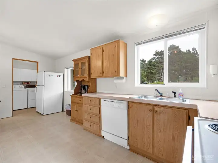Kitchen with ample cabinetry, large windows, and natural light.