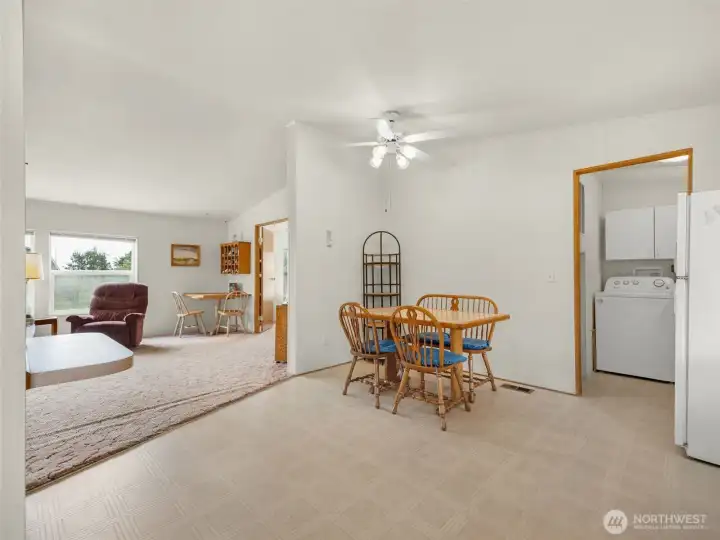 Dining area opening into the main living space with vaulted ceilings.