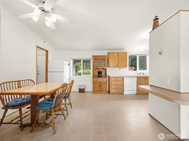 Spacious dining area with breakfast bar seating and open-concept layout.