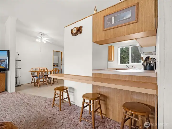 Breakfast bar seating connecting the kitchen and living room.