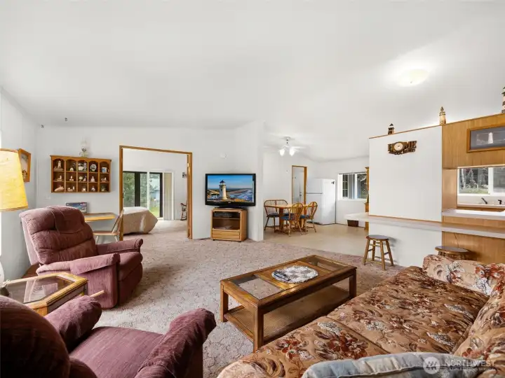 Living room with large windows and comfortable gathering space.