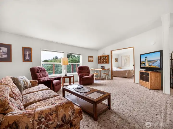 Main living area featuring large windows and easy indoor-outdoor flow.