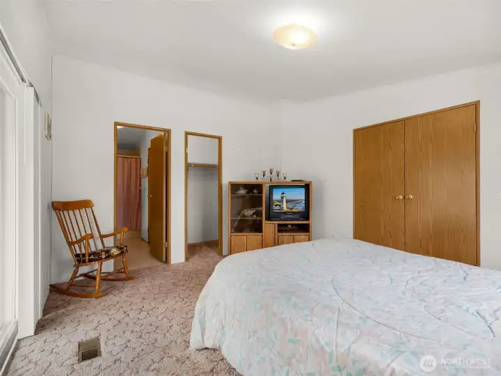 Alternate view of the primary bedroom with ensuite access and ample closet space.