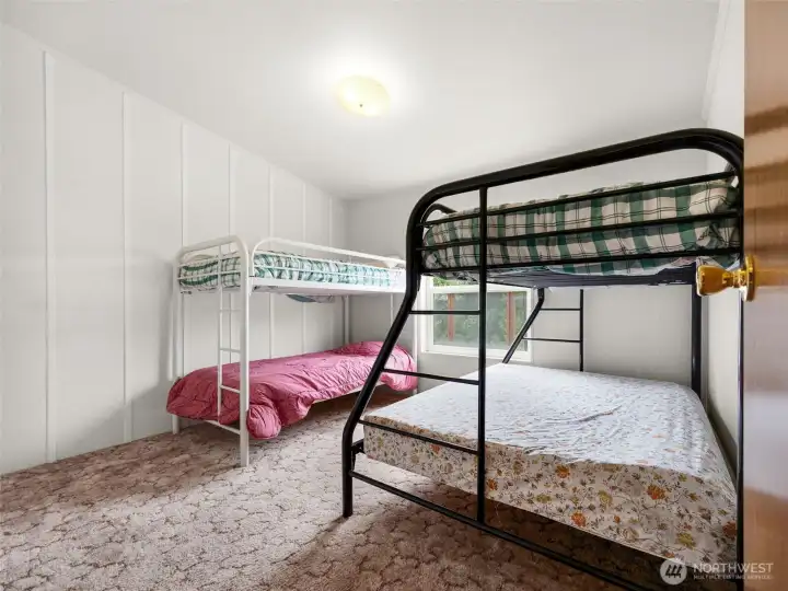 second bedroom with space for multiple sleeping arrangements, ideal for guests or extended stays.