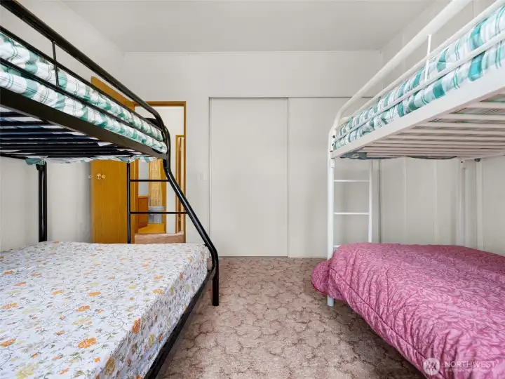 Additional view of the second bedroom with flexible sleeping and storage options.
