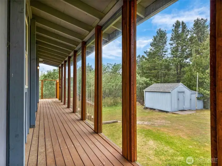 Covered deck overlooking the yard and canal setting.