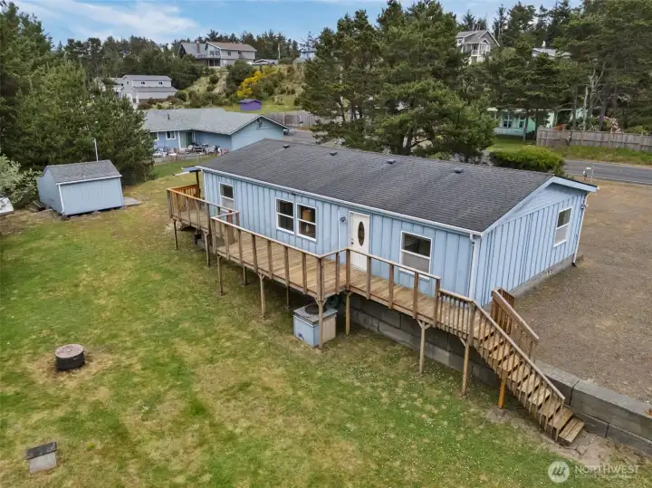 Elevated exterior view showing the home, deck, and canal-front setting.