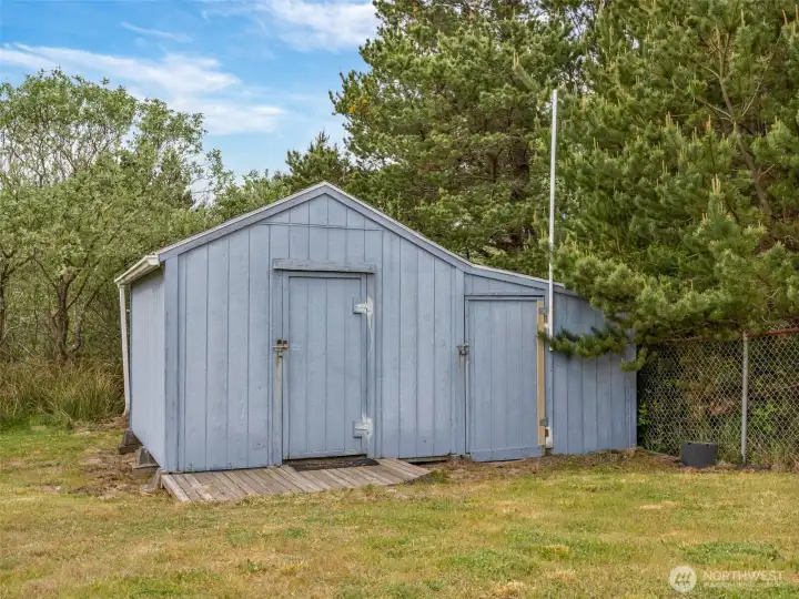 Detached storage shed offering additional space for tools, beach gear, or equipment.