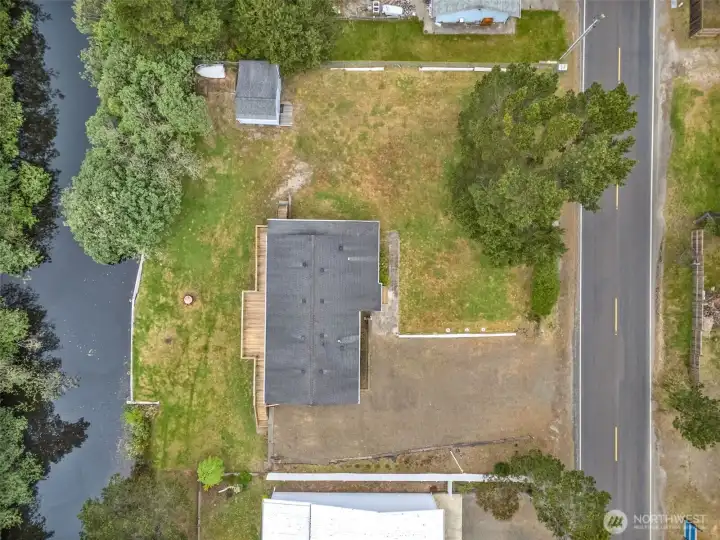 Overhead aerial view highlighting the full property layout, three lots, and canal frontage.