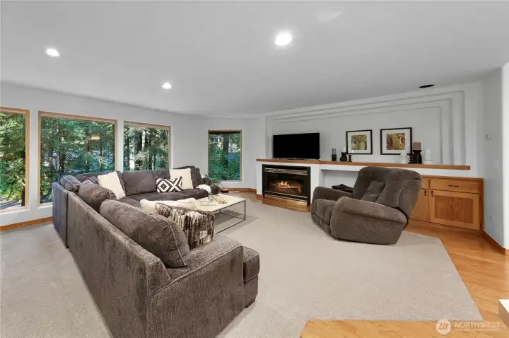 Gas fireplace and large windows looking to the trees.