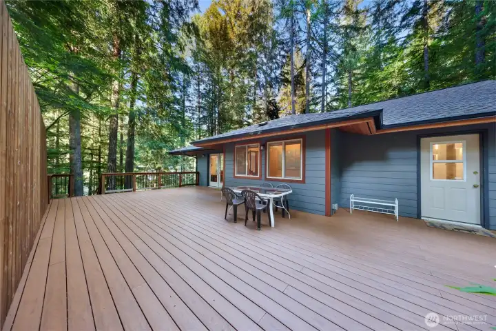 Back deck with composite decking and hot tub.