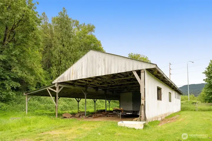 Large shop with covered parking for toys or equipment
