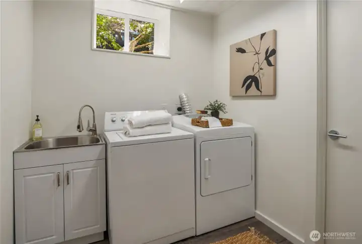 A full sized laundry room with laundry sink is located downstairs. A large storage room is off to the right. A full sized laundry room with laundry sink is located downstairs. A large storage room is off to the right.