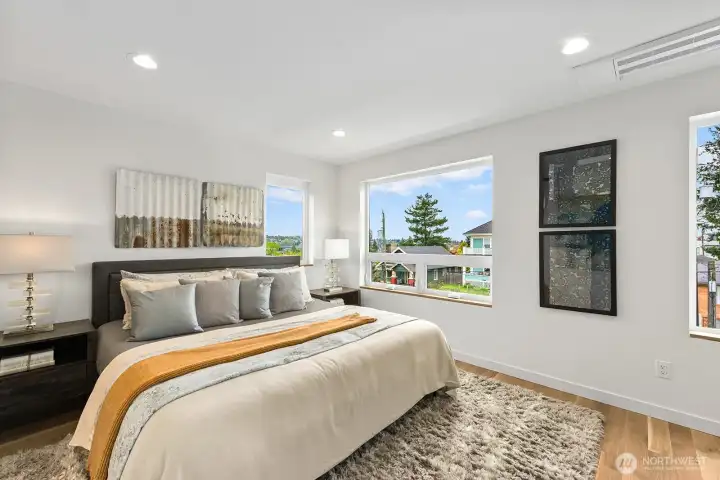 Primary suite with en suite spa-like bathroom and walk-in closet. Photo of model unit, 4116 A Burke Ave N - buyer to verify.