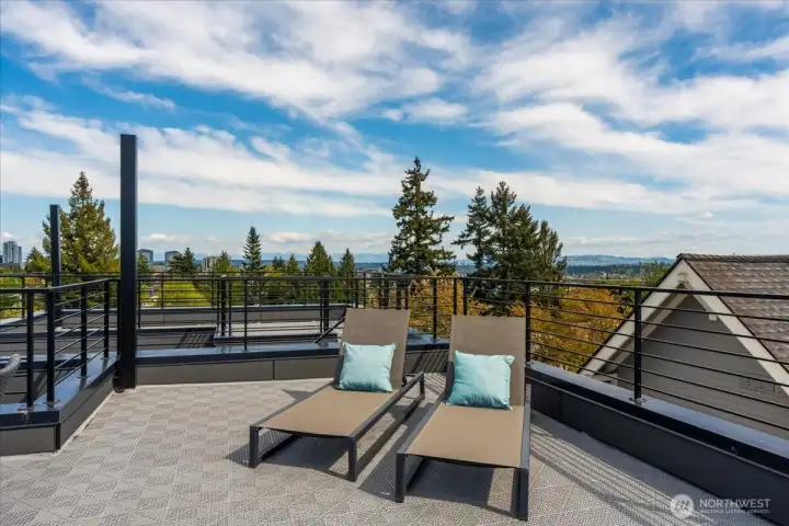 Parts of The Olympics, Cascades, Rainier, Space Needle, and cityscape are visible on a clear day. Photo of model unit, 4116 A Burke Ave N - buyer to verify.