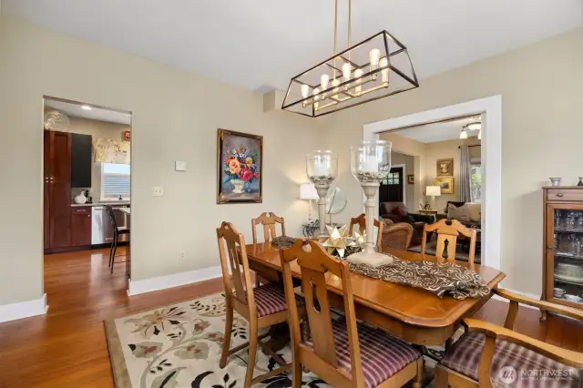 Looking across the dining room with the kitchen to the left and the living room through the open parlor doors.