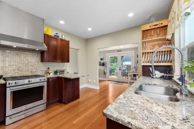 Looking across the kitchen toward the laundry room/bar area. The cherry cabinets and slab granite counters really make for an impressive combination and a lot of counter and storage space.