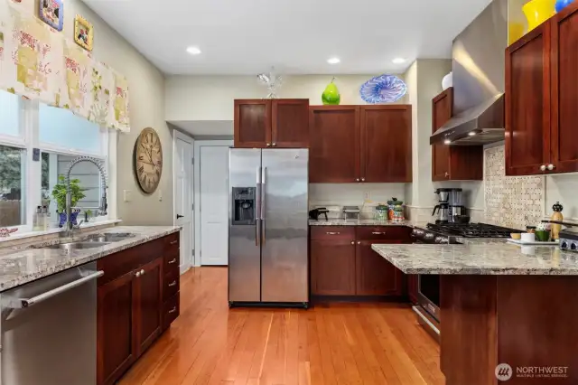 The kitchen is very spacious and beyond is the door to the basement and half bath.
