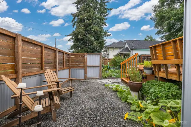 The rear yard is very special and is fully fenced with metal and wood.