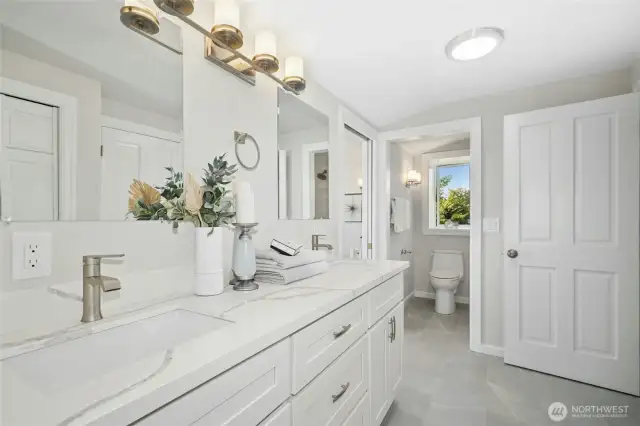 New cabinets, fixtures, tile floors and new tub and tile shower surround in room at rear