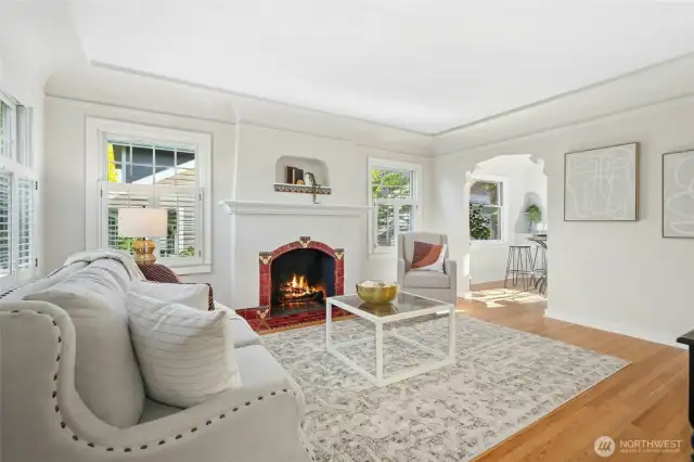 Inside you're greeted by the living room with fireplace tile that matches the period design. Notice the doorway cutouts - so unique!