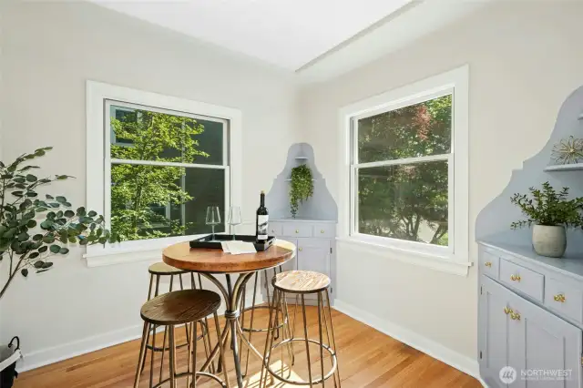 Dining nook with original built-in corner cupboards.