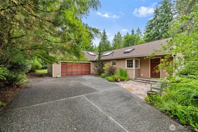 This single-level home is situated in an "oasis". It is so private from neighbors and the street and the .63 acres is bordered by towering evergreens and laurel that is placed so that the lake view is not blocked from the home.