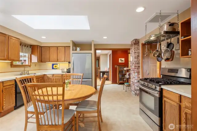 The eat-in kitchen is so light and bright with the large skylight above the table.