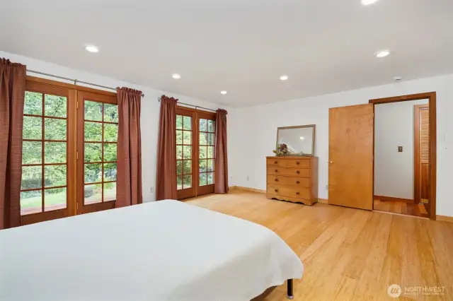 Another view of the primary bedroom with the laundry room across the hallway.