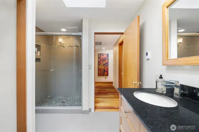 The bathroom off the primary bedroom has a gorgeous tiled shower and heated tile floors as well.