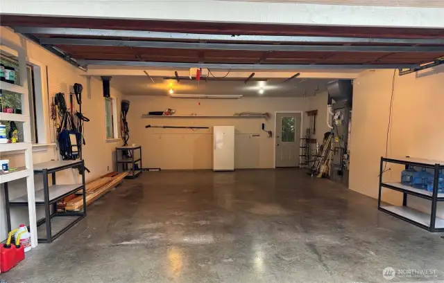 The garage is extra deep and has so much space. The door off the back opens to the rear/side yards and the 3 year old furnace is tucked in an alcove near the door. The furnace was plumbed for a heat pump should someone wish to add one. The hot water heater is also from 2022.