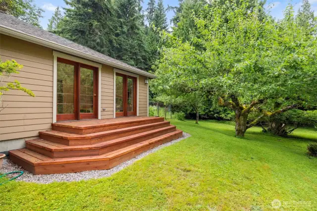 Another view of the very private deck that is off the primary bedroom. Look at the size of that King apple tree...it is so large and mature.