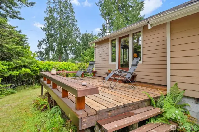 This spacious deck has 2" thick wood slabs and a bench seat all around and it is just off the living room.
