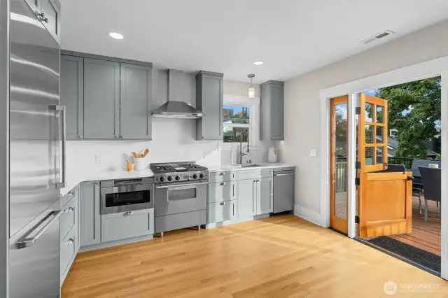 Sleek stainless steel appliances and quartz countertops elevate this chef’s kitchen—complete with access to a spacious deck for effortless indoor-outdoor living.