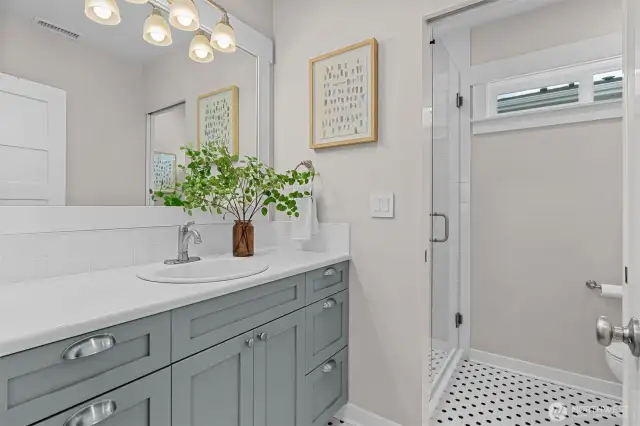 Main-level bathroom beautifully updated with sleek designer finishes for a fresh, modern feel.