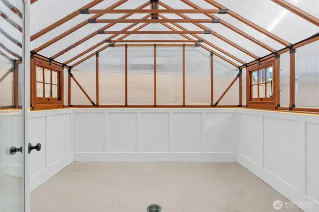 Light and bright interior sunroom or greenhouse—an inviting space to relax, grow, or create year-round.