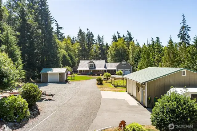 View from entering property, dog run out of sight near right side of house