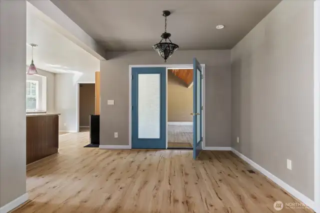Dining room with French doors to wrap around porch and kitchen to the left