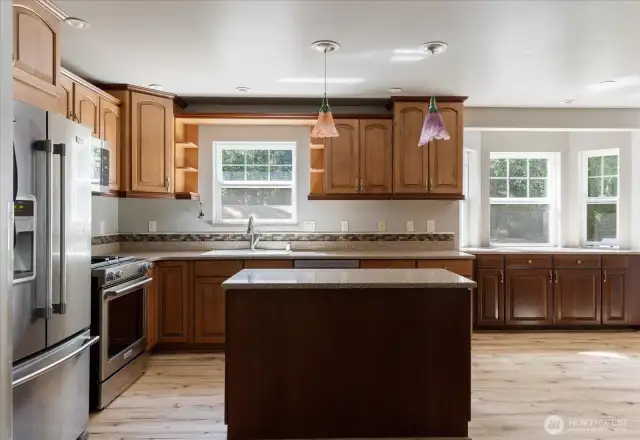 Custom kitchen with stainless steel appliances  including gas stove and island