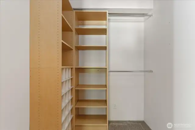 Primary walk in closet with built ins