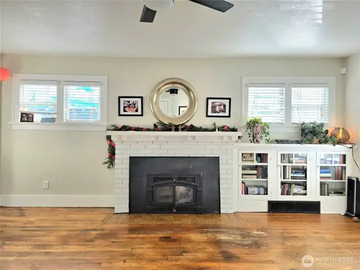 Wood stove and built ins with lots of windows. Great light!