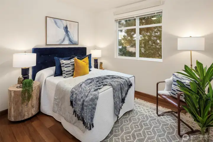 The cozy second bedroom is on the opposite side of the condo from the primary