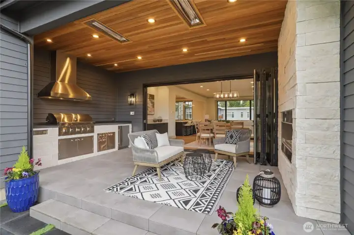 Enjoy a covered, heated patio designed for year-round comfort, with the ability to fully open for a seamless transition between indoor and outdoor entertaining. The exterior space is thoughtfully appointed with an outdoor fireplace, built-in BBQ, and refrigerator, all overlooking a rare, flat, and fully usable backyard.